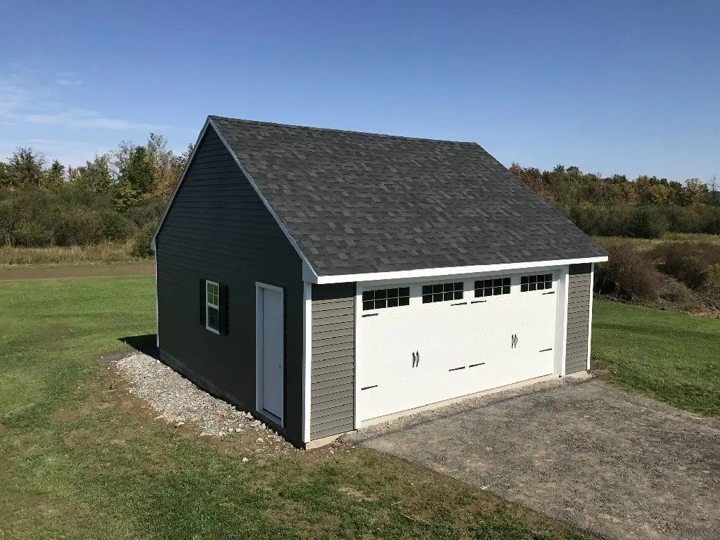 A garage with two doors and a black roof.