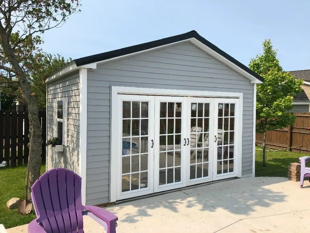 A shed with two sets of french doors open.