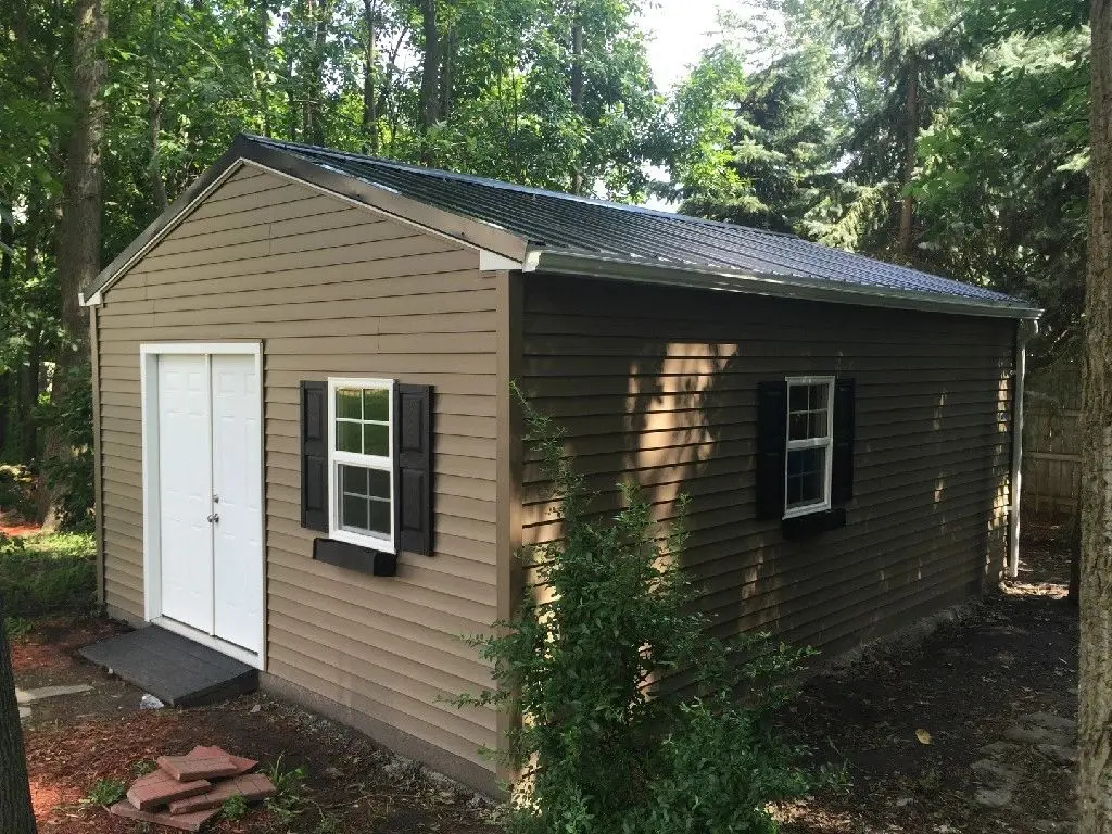 A shed with two windows and a door.