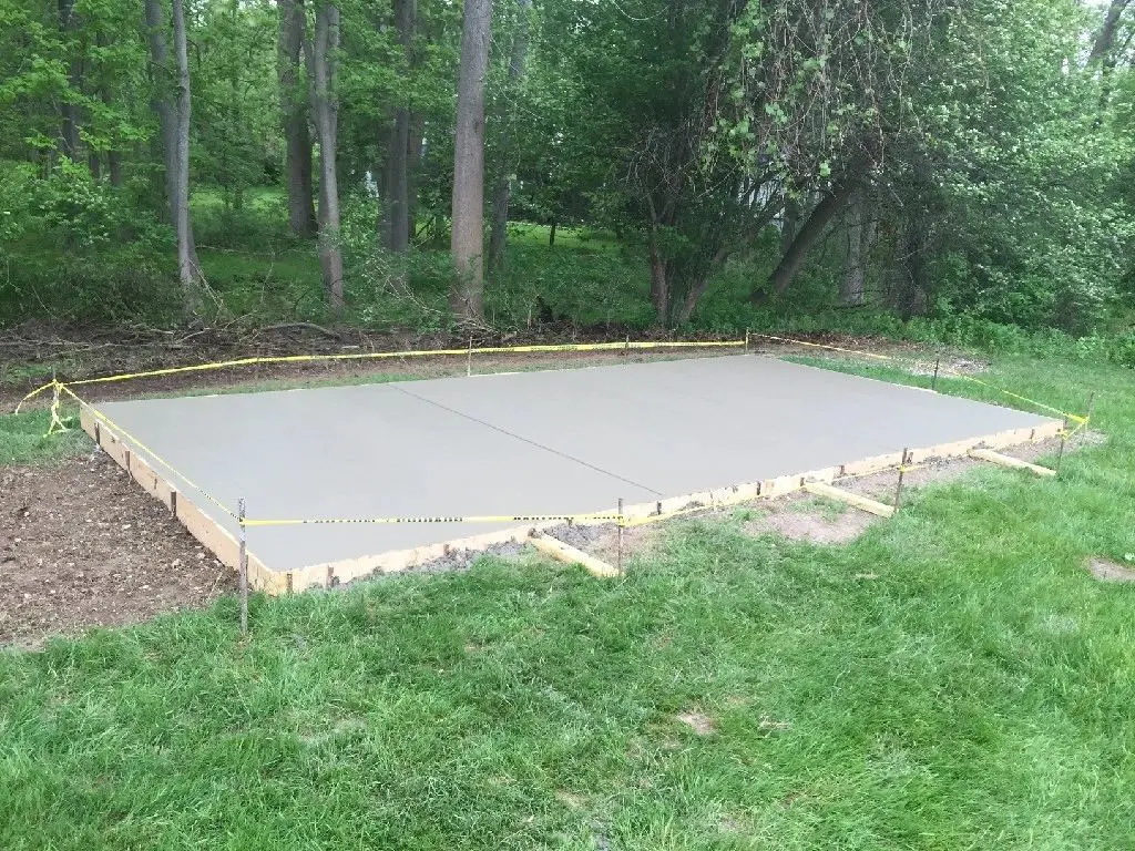A concrete slab is being built in the yard.