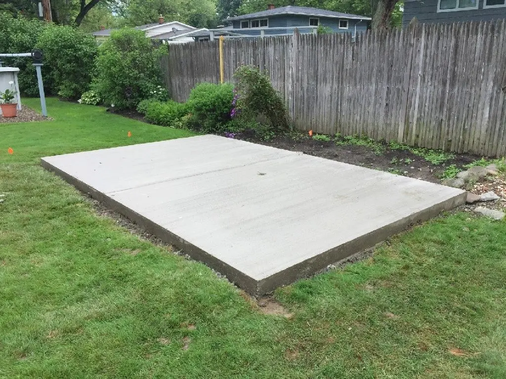 A concrete slab in the middle of a yard.