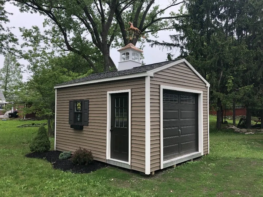 A shed with a garage door and a chimney.