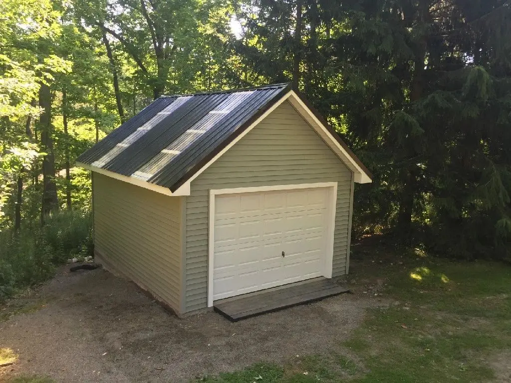 A garage with a solar panel on the roof.