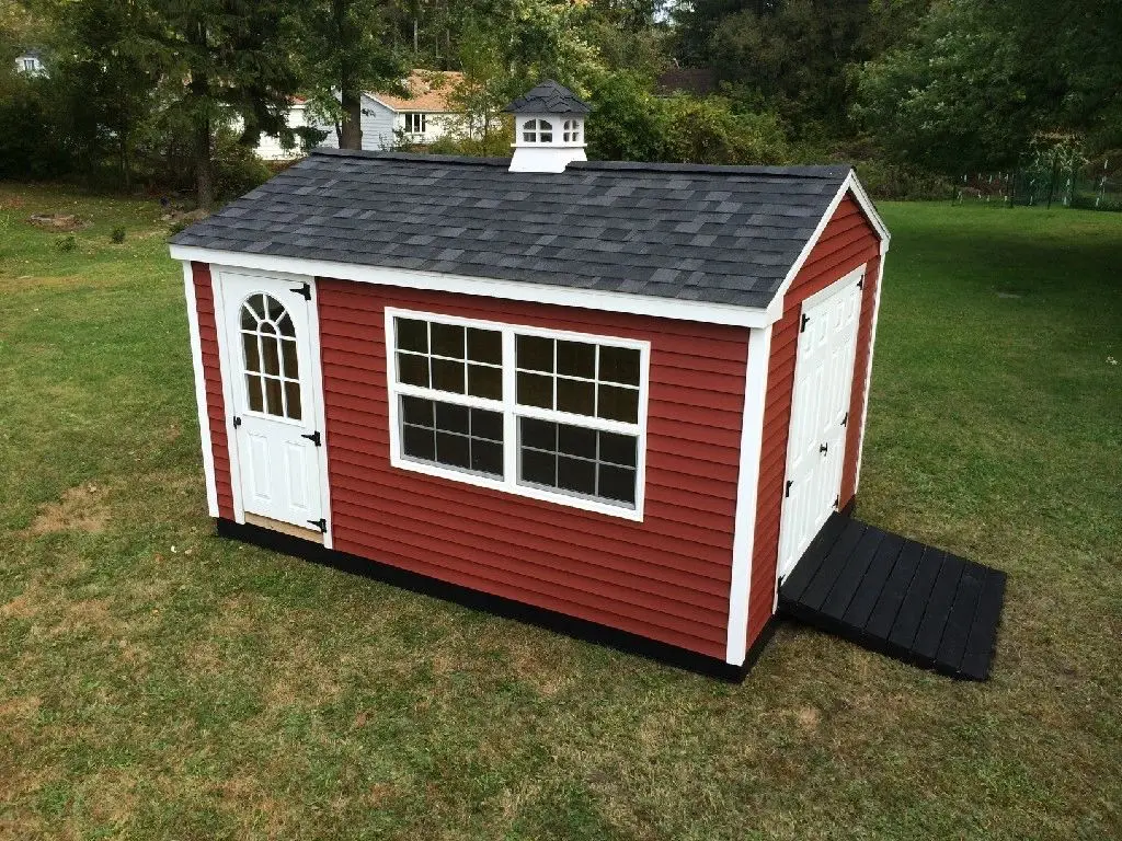A red shed with a black roof and white trim.