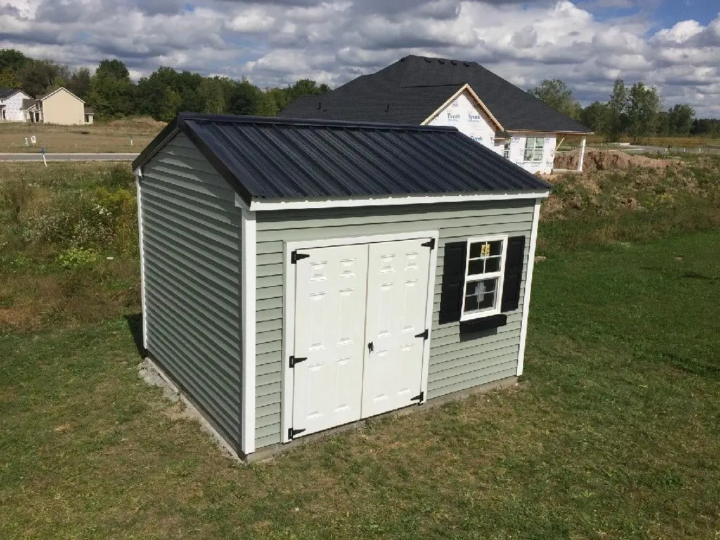 A shed with two windows and a black roof.