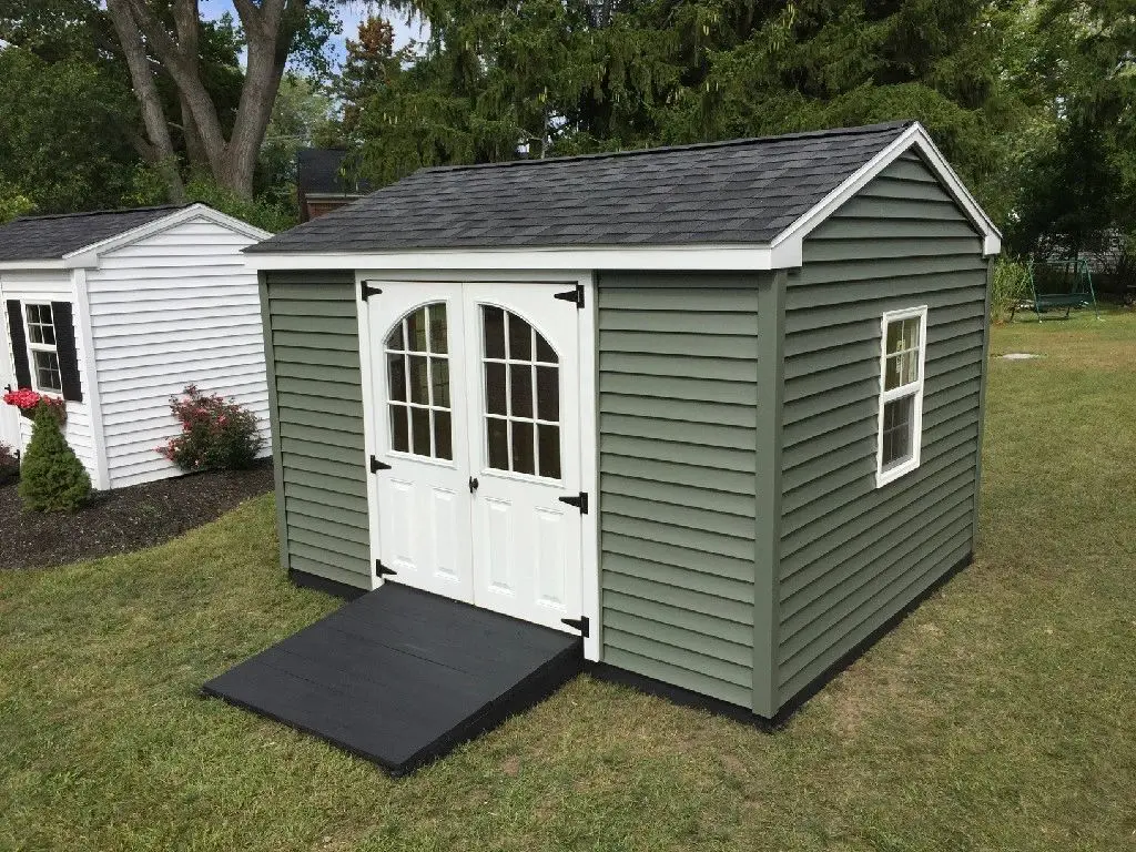 A green shed with a ramp in the front.