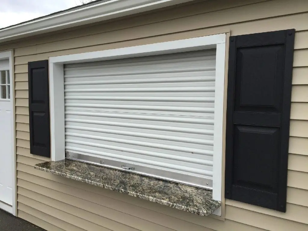 A garage door that is closed and has shutters on it.