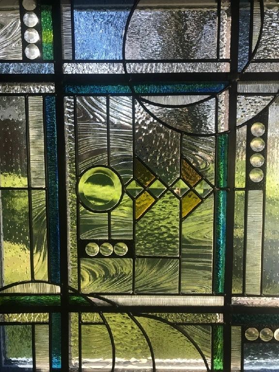 A stained glass window with a yellow ball on it.