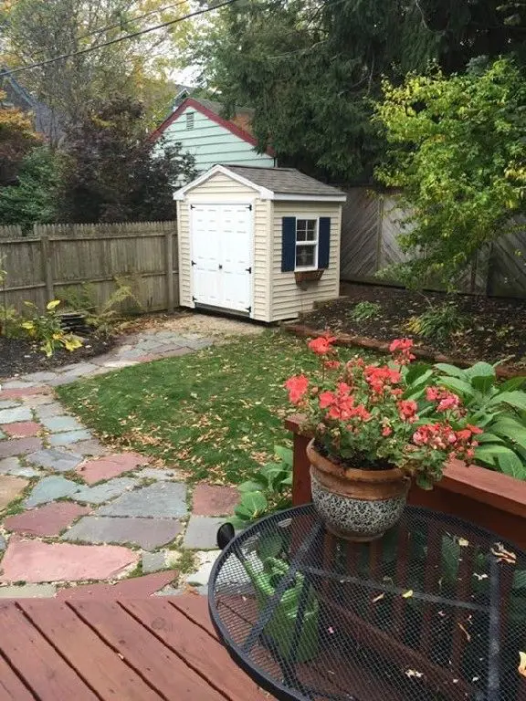 a small shed with white double doors