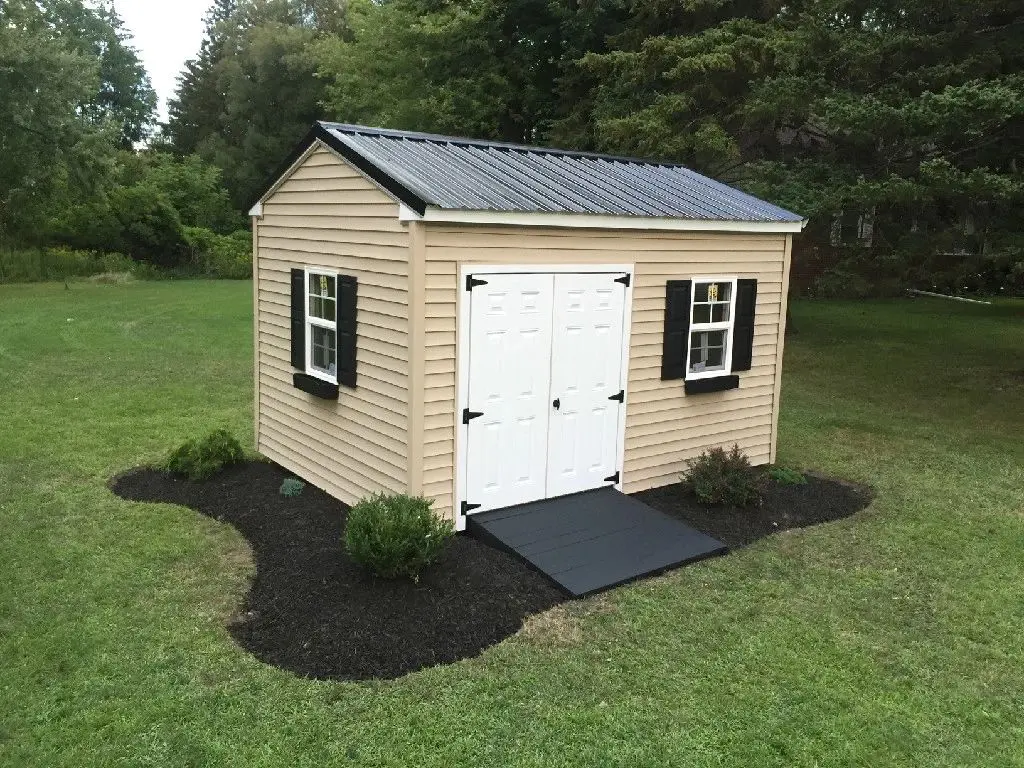 A small shed with two windows and a black roof.