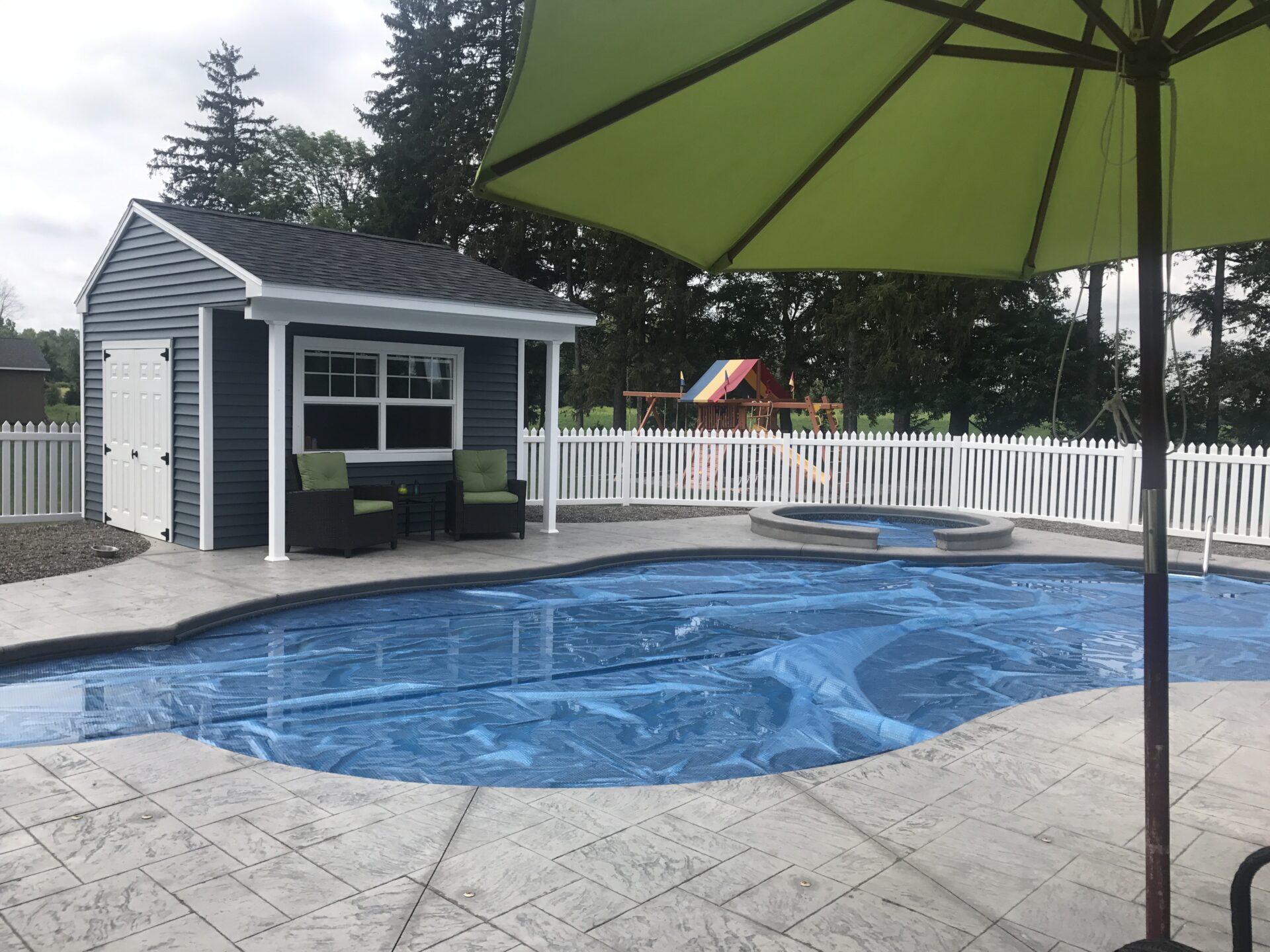 A pool with an umbrella in the middle of it