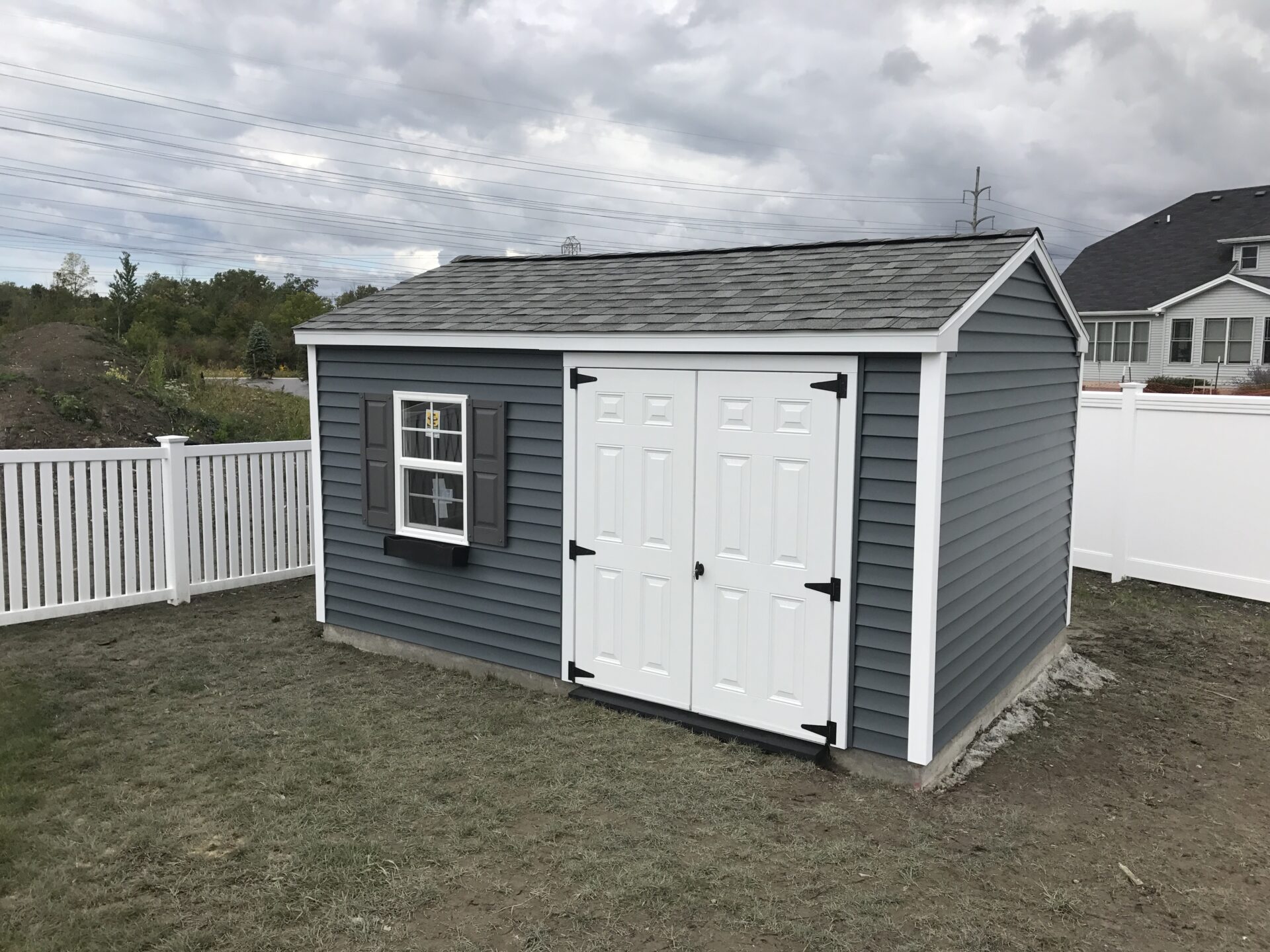 A shed with two doors and a window.