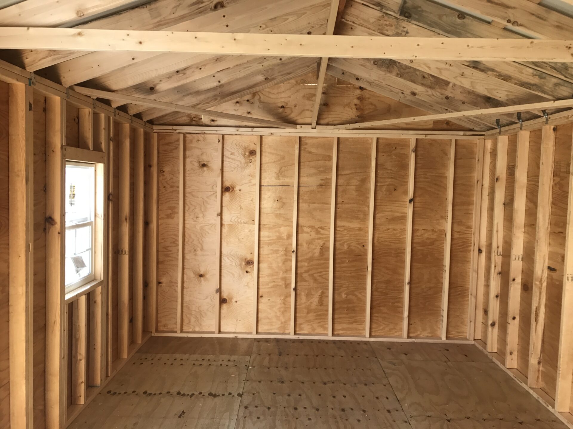 A room with wood paneling and a window.