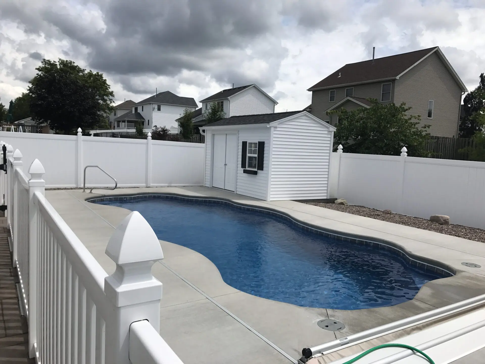 A pool that is in the yard of some kind.