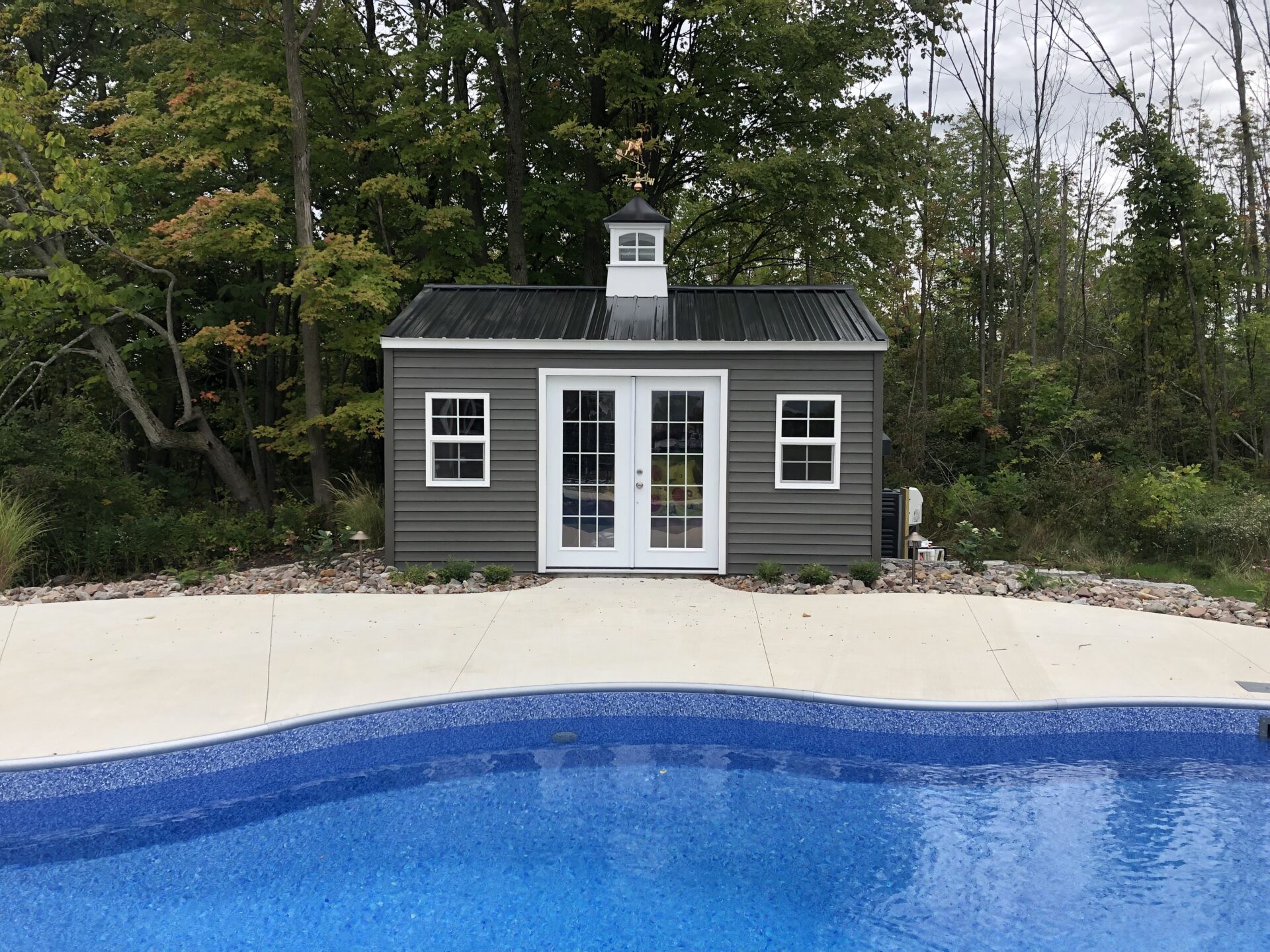 A pool house with a shed and a door.