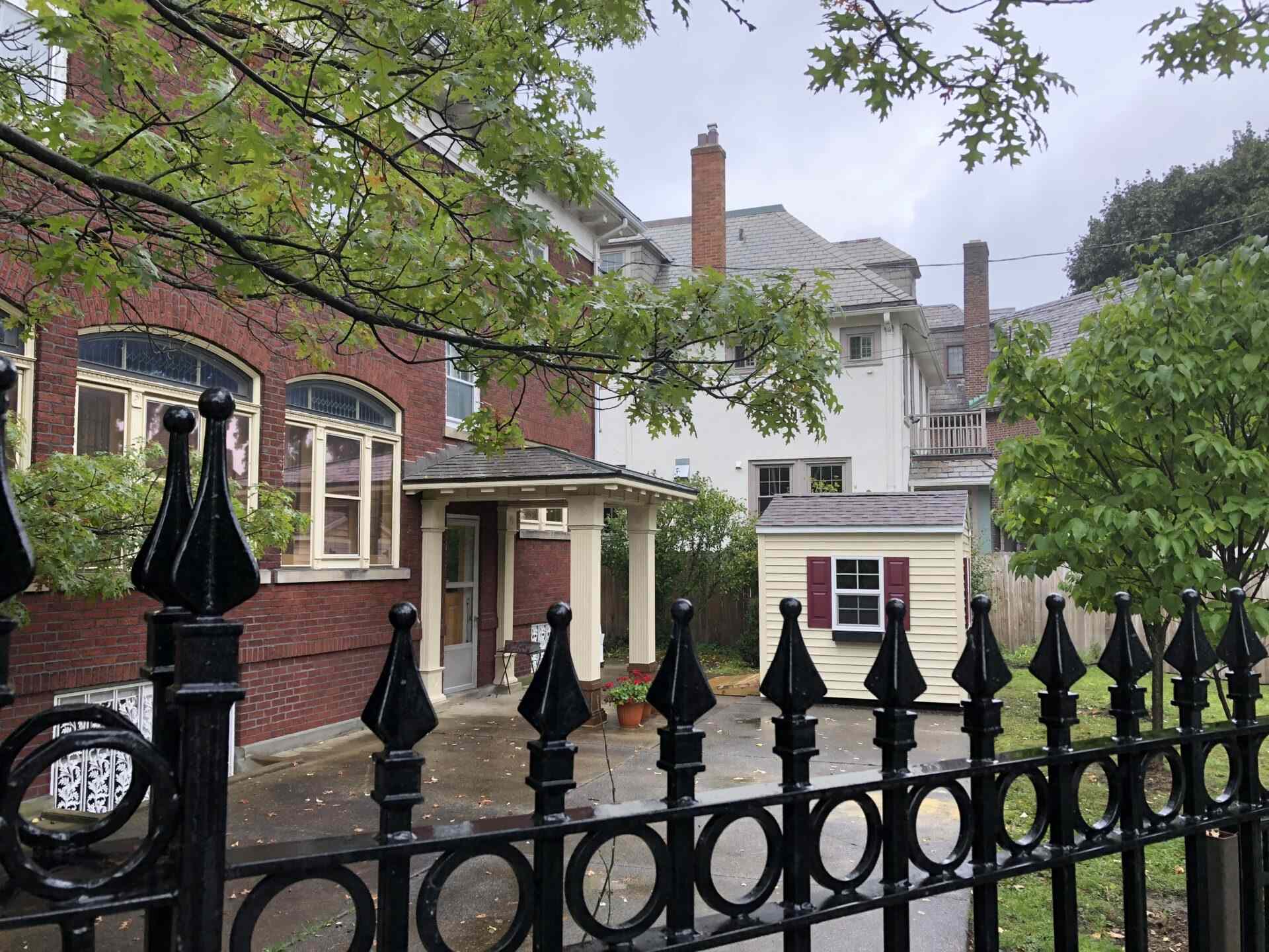 A black fence in front of some houses