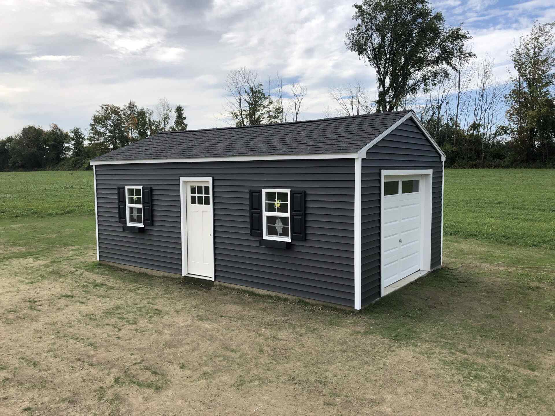 A shed with two windows and a door.