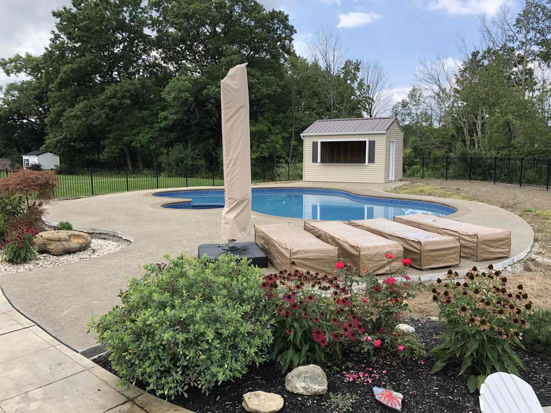 A pool with a covered area and a gazebo.